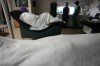 FILE - A woman naps, bundled up against the air conditioning, as she waits to have an abortion, Saturday, Oct. 9, 2021, at Hope Medical Group for Women in Shreveport, La. A bill scheduled for debate Thursday, May 12, 2022, in the Louisiana House would make women who get abortions subject to criminal prosecution and prison — a position that has drawn opposition from Louisiana’s anti-abortion governor and groups including Louisiana Right to Life and the Louisiana Conference of Catholic Bishops. (AP Photo/Rebecca Blackwell, File)