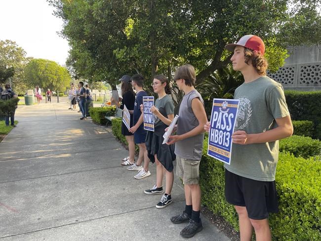 Anti-abortion demonstrators outside the Louisiana Capitol show support for legislation that would subject women who get abortions to possible murder charges on Thursday, May 12, 2022 in Baton Rouge, La. The legislation was to be debated Thursday night by state House members. (AP Photo/Kevin McGill)