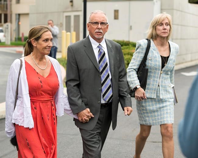 FILE - Former UCLA gynecologist Dr. James Heaps, center, with his wife Deborah, left, and defense attorney Tracy Green leave Los Angeles Superior Court, on June 26, 2019. The University of California has agreed to pay $375 million to more than 300 women who said they were sexually abused by a longtime UCLA gynecologist. The announcement Tuesday, May 24, 2022, brings total payouts by the university in lawsuits against Dr. Heap to nearly $700 million. That's the largest amount paid by a public university in a wave of sexual misconduct scandals involving campus doctors. (AP Photo/Damian Dovarganes, File)