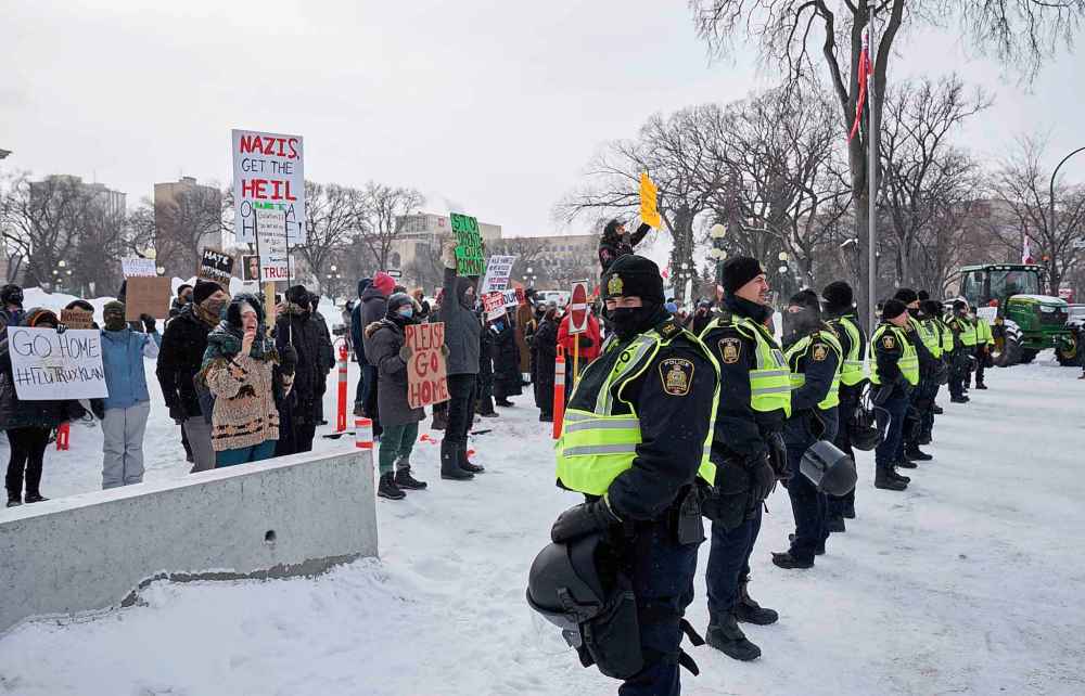 Winnipeg police officers kept the counter protesters and the anti-mandate protesters separate during the rally at the Manitoba Legislature Saturday. But the Winnipeg Police Service is under fire for detaining two Indigenous counter-protesters under the Intoxicated Persons Detention Act. (David Lipnowski / Winnipeg Free Press files)