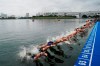 FILE - In this Aug. 15, 2019, file photo, athletes dive into the water at the start line during a women's triathlon test event at Odaiba Marine Park, a venue for marathon swimming and triathlon at the Tokyo 2020 Olympics, in Tokyo. The IOC moved next year’s Tokyo Olympic marathons and race walks out of the Japanese capital to avoid the stifling heat and humidity. Some swimmers and an 11,000-member coaching body want similar treatment: find an alternative to the distance-swimming venue in Tokyo Bay known as the “Odaiba Marine Park.”(AP Photo/Jae C. Hong, File)