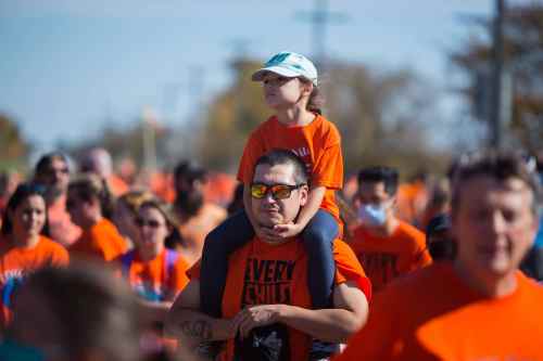 Brandon Sun Hundreds gather for the Orange Shirt Day walk trekking from the Riverbank Discovery Centre to the site of the former Brandon Residential School Thursday.  (Chelsea Kemp/The Brandon Sun)
