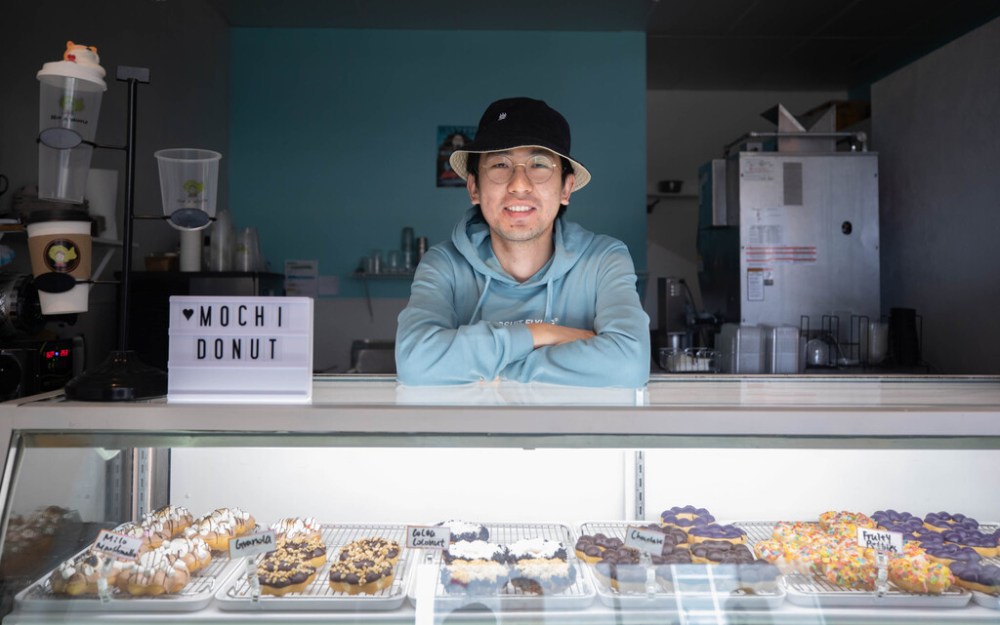 Mumu Ma is usually in the shop by 7 a.m. to make the day’s batch of treats. His favourite flavour is the Fruity Pebbles variety, a glazed doughnut topped with cereal. (Jessica Lee / Winnipeg Free Press)