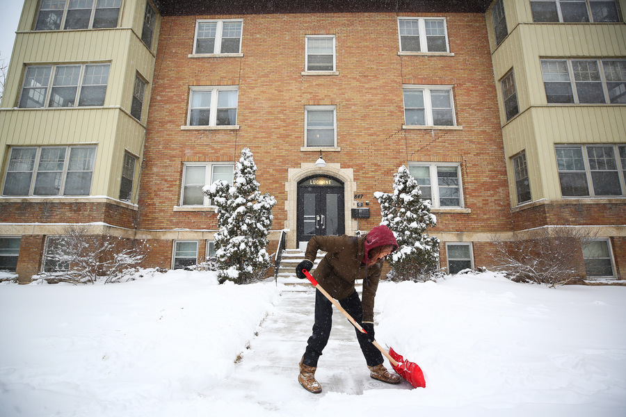 MIKE DEAL / WINNIPEG FREE PRESS
Florance Smith shovels the front steps of the apartment building she manages on McMillan Avenue on Thursday morning. (Mike Deal / Winnipeg Free Press)
220414 - Thursday, April 14, 2022