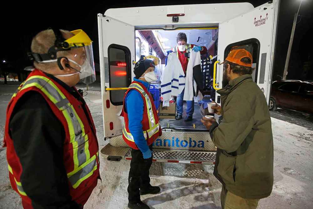 JOHN WOODS / WINNIPEG FREE PRESS
Merv Halvorsen, a pastor with Salvation Army (SA), and SA cadets John Burton and Kathryn Dueck feed and support people as they drive around in their Extreme Environment Response Vehicle in downtown Winnipeg Saturday, April 4, 2020.
Reporter: Thorpe