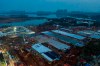 In this Tuesday, Jan. 28, 2020, photo, construction workers labor at the site of the Huoshenshan temporary field hospital being built in Wuhan in central China's Hubei Province. China as of Wednesday has more infections of a new virus than it did in with SARS, though the death toll is still lower. (Chinatopix via AP)