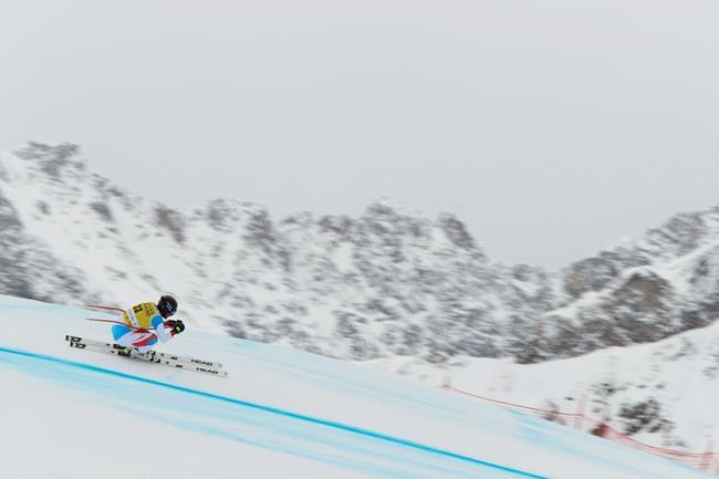 Switzerland's Gilles Roulin speeds down the course during training for an alpine ski, men's World Cup downhill, in Val d'Isere, France Friday, Dec. 11, 2020. (AP Photo/Gabriele Facciotti)