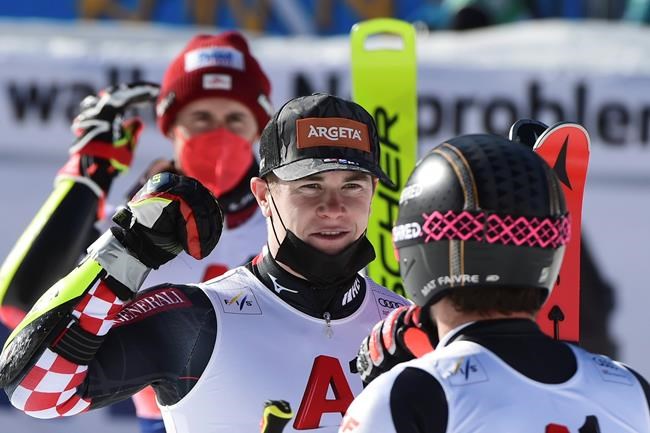 Winner Filip Zubcic of Croatia, center, celebrates with second placed Mathieu Faivre of France, right, and third placed Stefan Brennsteiner of Austria, in the finish area of an alpine ski, men's World Cup giant slalom, in Bansko, Saturday, Feb. 27, 2021. (AP Photo/Marco Tacca)