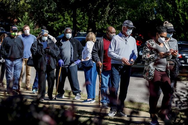 Republican nominee for the Alabama Senate, Tommy Tuberville (third from right), stands in a long line waiting to cast his vote on Tuesday, Nov. 3, 2020, in Auburn, Ala. (AP Photo/Butch Dill)