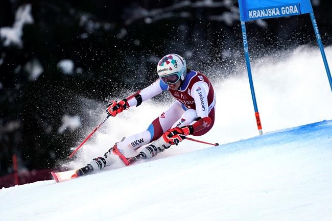 Switzerland's Michelle Gisin speeds down the course of an alpine ski, women's World Cup giant slalom, in Kranjska Gora, Slovenia, Saturday, Jan. 16, 2021. (AP Photo/Giovanni Auletta)
