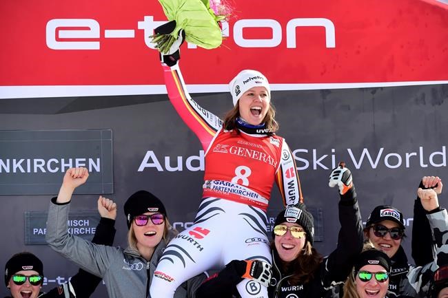 FILE - In this Saturday, Feb. 8, 2020 file photo, first placed Germany's Viktoria Rebensburg celebrates on the podium of an alpine ski, women's World Cup downhill, in Garmish Partenkirchen, Germany. Rebensburg, who won the Olympic gold medal in giant slalom in 2010, announced her retirement Tuesday, Sept. 1, 2020 at the age of 30 after an injury. (AP Photo/Marco Tacca, File)