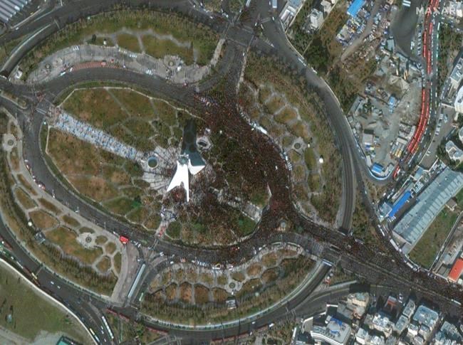 This Monday, Jan. 6, 2020 satellite photo from Maxar Technologies shows Azadi Tower in Tehran, Iran, amid a mass processional for Iranian Gen. Qassem Soleimani, who was killed in a U.S. airstrike in Baghdad. The funeral for Soleimani drew a crowd said by police to be in the millions in the Iranian capital, filling thoroughfares and side streets as far as the eye could see. Although there was no independent estimate, aerial footage and Associated Press journalists suggested a turnout of at least 1 million. (Satellite image ©2020 Maxar Technologies via AP)