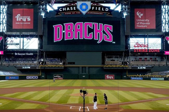 Arizona Diamondbacks' Nick Ahmed, left, talks with Colorado Rockies' Daniel Murphy after the Rockies decided not to play their baseball game against the Diamondbacks, Thursday, Aug. 27, 2020, in Phoenix. (AP Photo/Matt York)