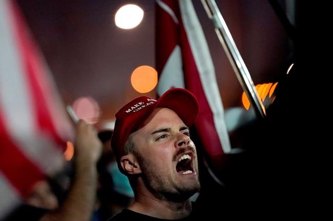 Supporters of President Donald Trump rally outside the Maricopa County Recorders Office, Wednesday, Nov. 4, 2020, in Phoenix. (AP Photo/Matt York)