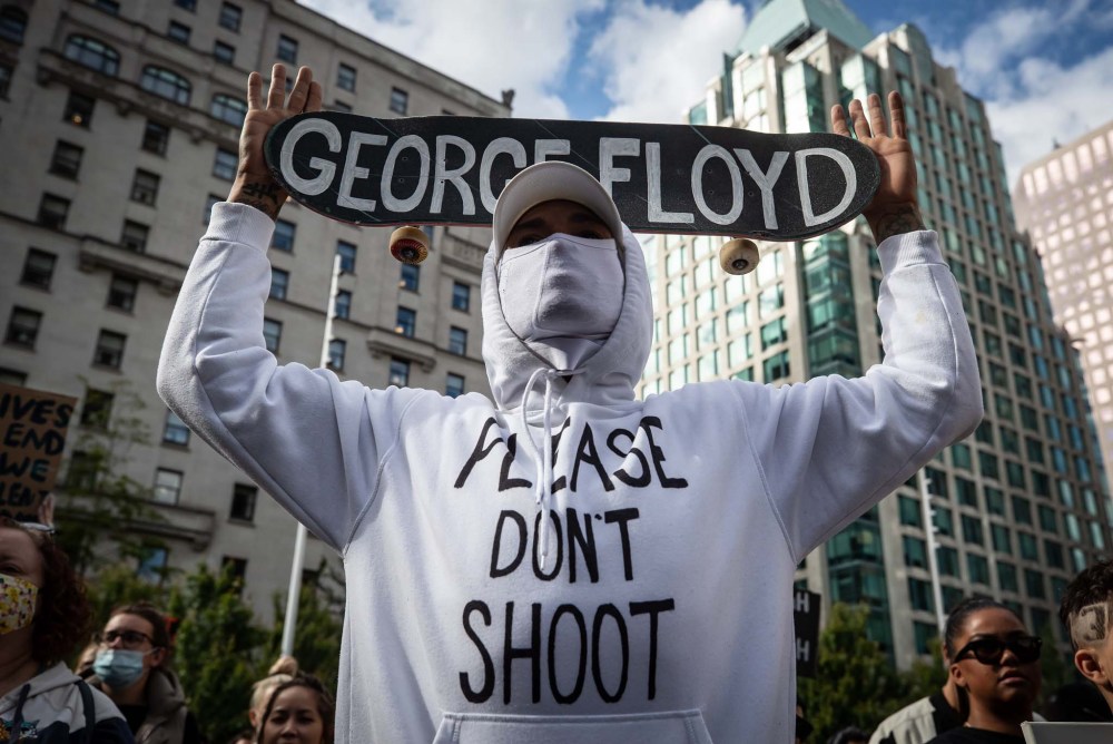 Darryl Dyck / Canadian Press files
A man holds a skateboard bearing George Floyd's name above his head as thousands of people gather Sunday for a peaceful demonstration in support of Floyd and Regis Korchinski-Paquet and protest against racism, injustice and police brutality in Vancouver.