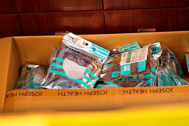 A box of masks imported from Japan sits inside a Yifeng Pharmacy in Wuhan, China, January 22, 2020. Pharmacies in Wuhan are restricting customers to buying one mask at a time amid high demand and worries over an outbreak of a new coronavirus. The number of cases of the new virus has risen to over 400 in China and the death toll to 9, Chinese health authorities said Wednesday. (AP Photo/Dake Kang)