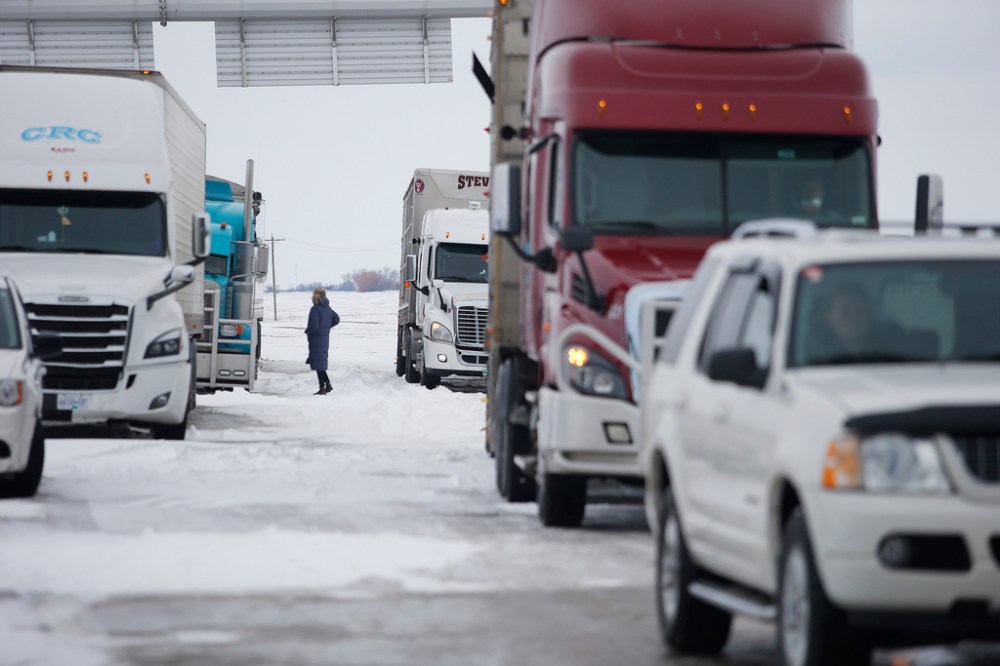 CP
A person speaks to truckers as they block highway 75 with heavy trucks and farm equipment and access to the Canada/US border crossing at Emerson, Thursday. THE CANADIAN PRESS/John Woods
