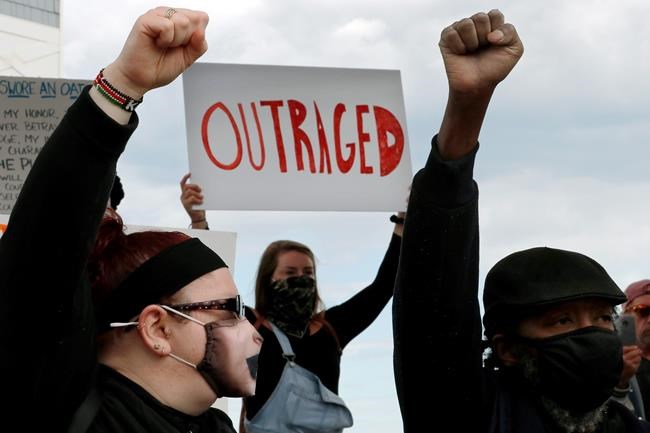 People gather to protest in Hampton Beach, N.H., Monday, June 1, 2020, following the death of George Floyd, who died after being restrained by Minneapolis police officers on Memorial Day. (AP Photo/Charles Krupa)