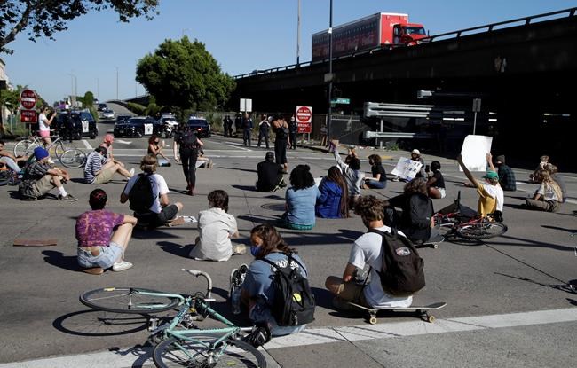 Protestors block an intersection outside the Oakland police department on Thursday, May 28, 2020, in Oakland, Calif. (AP Photo/Ben Margot)