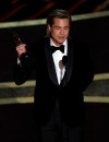 Brad Pitt accepts the award for best performance by an actor in a supporting role for 