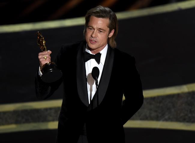 Brad Pitt accepts the award for best performance by an actor in a supporting role for