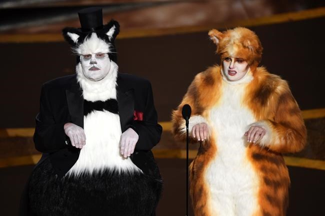 James Corden, left, and Rebel Wilson present the award for best visual effects at the Oscars on Sunday, Feb. 9, 2020, at the Dolby Theatre in Los Angeles. (AP Photo/Chris Pizzello)