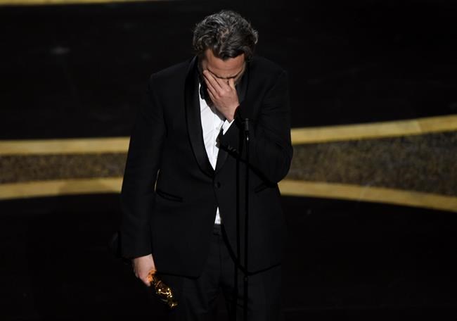 Joaquin Phoenix reacts as he accepts the award for best performance by an actor in a leading role for