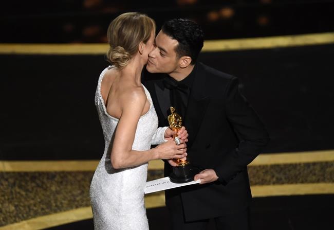 Renee Zellweger, left, accepts the award for best performance by an actress in a leading role for