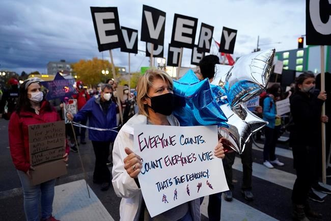 People march during a protest after the Nov. 3 elections, Wednesday, Nov. 4, 2020, in Portland, Ore. (AP Photo/Marcio Jose Sanchez)
