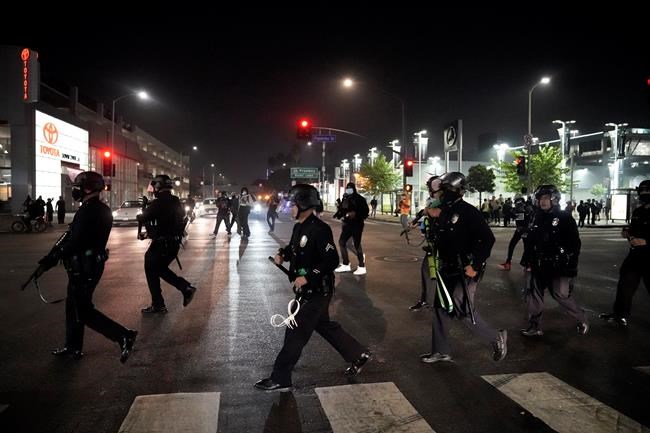 Police move into position during a protest on Election Day, Tuesday, Nov. 3, 2020, in Los Angeles. (AP Photo/Jae C. Hong)