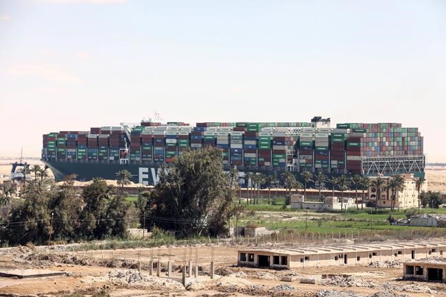 Ever Given, a Panama-flagged cargo ship blocks the Suez Canal almost a week after it got stuck sideways in the crucial waterway, Monday, March 29, 2021. Engineers on Monday