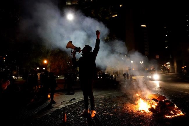 A protester yells after a march to the Mark O. Hatfield United States Courthouse on the night of the election, Tuesday, Nov. 3, 2020, in Portland, Ore. (AP Photo/Marcio Jose Sanchez)