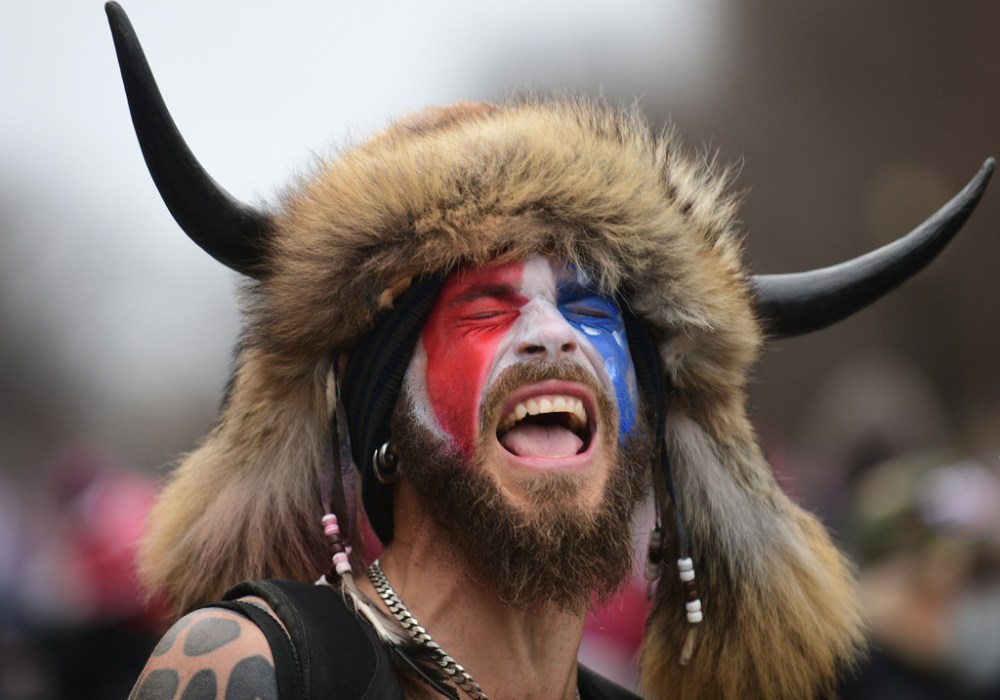 Jake Angeli stormed the Capitol building wearing buffalo horns, raccoon fur, face paint, feathers, beads and a spear. (Astrid Riecken / The Washington Post files)