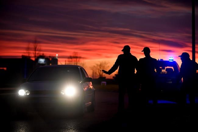 Police stops cars trying to enter or leave the cordoned area in Casalpusterlengo, Northern Italy, Sunday, Feb. 23, 2020. A dozen Italian towns saw daily life disrupted after the deaths of two people infected with the virus from China and a pair of case clusters without direct links to the outbreak abroad. A rapid spike in infections prompted authorities in the northern Lombardy and Veneto regions to close schools, businesses and restaurants and to cancel sporting events and Masses. (Claudio Furlan/LaPresse via AP)
