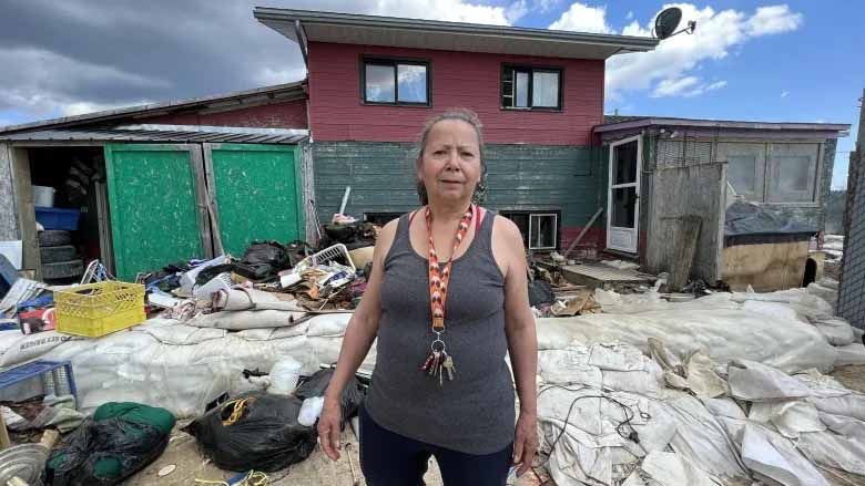 Cheryl Thomson returned to Peguis First Nation this week to find her home and the possessions inside — now strewn about her yard to dry — badly damaged. The community began cleanup efforts this week, which includes inviting residents back to help officials get a handle of the extent of the damage to their homes. (Travis Golby / CBC)