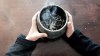 A child holds a bowl with burning sage in a 2016 photo. Sage is used in the practice of smudging, but dry conditions in Manitoba this year mean some groups are having trouble finding it. (Martha Troian/CBC)
