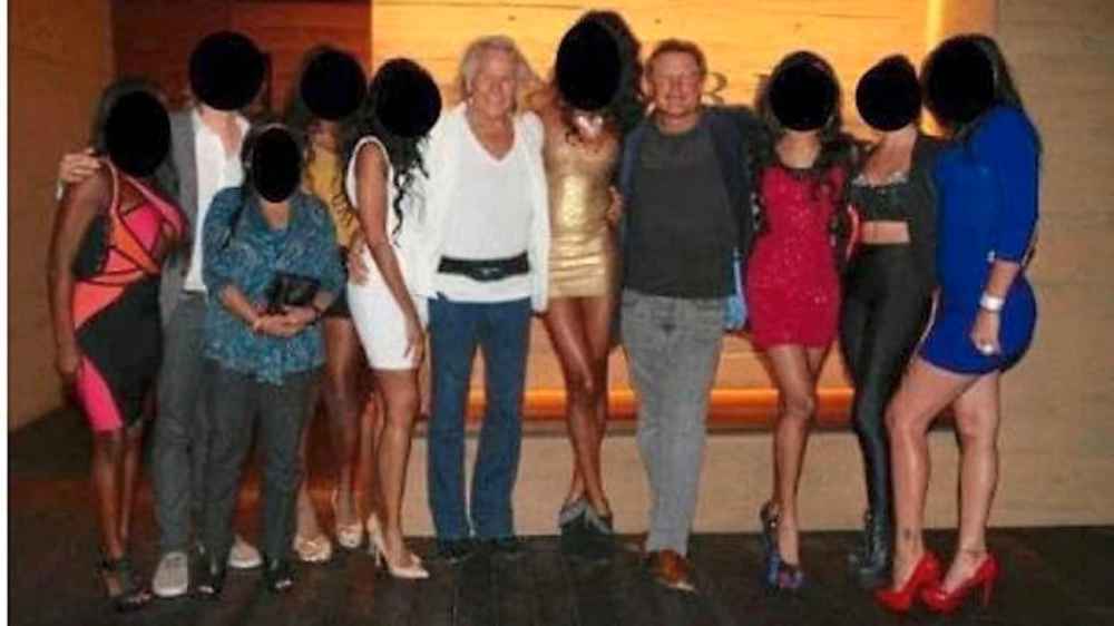 This photo, included in the lawsuit, calls Daniel Fitzgerald, fourth from right, a longtime friend and associate of Peter Nygard, centre. The lawsuit alleges Fitzgerald
