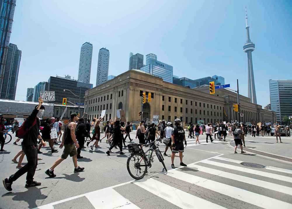 Thousands of people protest at an anti-racism demonstration reflecting anger at the police killings of black people, in Toronto on Friday, June 5, 2020. THE CANADIAN PRESS/Nathan Denette