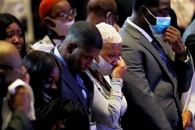 Shareeduh Tate, second from left, reacts during an 8:46 pause during a memorial service for George Floyd at North Central University Thursday, June 4, 2020, in Minneapolis. (AP Photo/Julio Cortez)