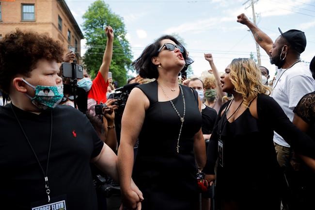 Justin Diamond, center, the fiancé of George Floyd reacts after a memorial service for Floyd at North Central University Thursday, June 4, 2020, in Minneapolis. (AP Photo/Julio Cortez)