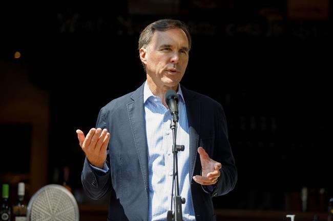 Finance Minister Bill Morneau speaks to media during a press conference in Toronto, Friday, July 17, 2020. The opposition parties are asking the federal ethics watchdog to widen his probe of Morneau regarding the WE organization as the finance minister continues to face calls for his resignation. THE CANADIAN PRESS/Cole Burston