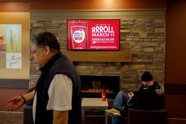 Signage for Tim Hortons' Roll Up the Rim contest is seen inside a Tim Hortons restaurant in Toronto, Friday, March 6, 2020. THE CANADIAN PRESS/Cole Burston