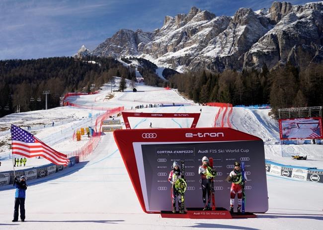 FILE - In this Sunday, Jan. 20, 2019 file photo, United States' Mikaela Shiffrin, center, winner of an alpine ski, women's World Cup super-G, poses on the podium with second placed Liechtenstein's Tina Weirather, left, and third placed Austria's Tamara Tippler, in Cortina D'Ampezzo, Italy. The natural beauty of Cortina will be of special importance at the alpine ski World championships, with organizers hoping that the images from the slopes beamed around the globe to TV viewers will make up for the lack of fans amid the coronavirus pandemic. (AP Photo/Giovanni Auletta, File)