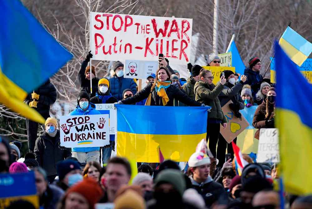The Canadian Press
People rally against Russia’s invasion of Ukraine during a protest outside City Hall in Ottawa, on Sunday, Feb. 27, 2022. (Justin Tang / The Canadian Press)
