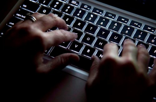 A woman uses her computer keyboard to type while surfing the internet in North Vancouver, B.C., on December, 19, 2012. A U.S. cyber security company says criminal groups are exploiting fears over the new coronavirus to attack the global shipping industry.California-based Proofpoint says it has detected a new email campaign that uses Microsoft Word attachments designed to trick recipients into installing a type of malware known as AZORult. THE CANADIAN PRESS/Jonathan Hayward