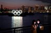 Two women take a selfie with the Olympic rings in the background in the Odaiba section of Tokyo, Thursday, March 12, 2020. THE CANADIAN PRESS/Jae C. Hong