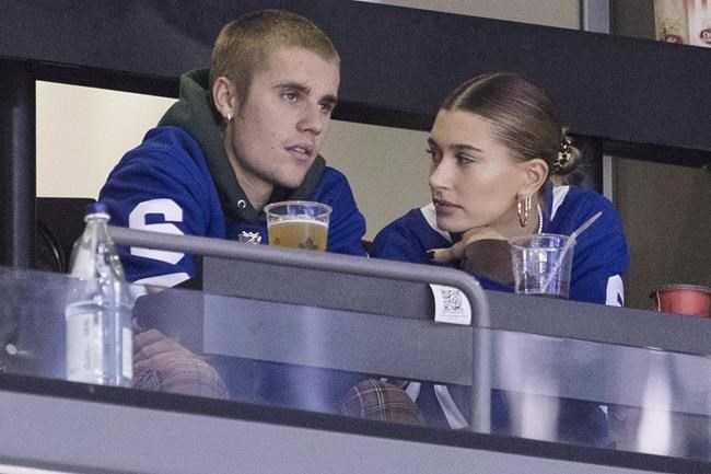 Justin Bieber watches alongside his wife Hailey Baldwin, right, during NHL hockey action between the Philadelphia Flyers and the Toronto Maple Leafs, in Toronto on Saturday, Nov. 24, 2018. If Tim Hortons hopes to win over coffee drinkers with its revamped cup lid, count pop superstar Bieber out.THE CANADIAN PRESS/Chris Young