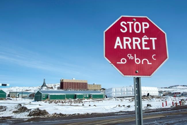 A stop sign in English, French and Inuit is seen in Iqaluit, Nunavut on April 25, 2015. The Inuit Circumpolar Council says if the novel coronavirus spreads to the north its communities in Canada, Alaska and Greenland are at a much higher risk of exposure because of a chronic lack of basic infrastructure and resources. The group says the Inuit must be considered in the government's national and regions response and preparedness plans for coronavirus and the potential compounding threat to basic health and well-being in those communities. THE CANADIAN PRESS/Paul Chiasson