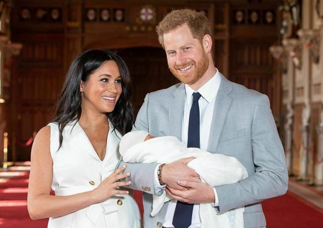 FILE - In this Wednesday May 8, 2019 file photo, Britain's Prince Harry and Meghan, Duchess of Sussex, during a photocall with their newborn son, in St George's Hall at Windsor Castle, England. A local mayor says Prince Harry and Meghan Markle chose the perfect place to rest and relax over the holiday season before announcing their decision to step back as senior members of the Royal Family. THE CANADIAN PRESS/Dominic Lipinski/Pool via AP, file)