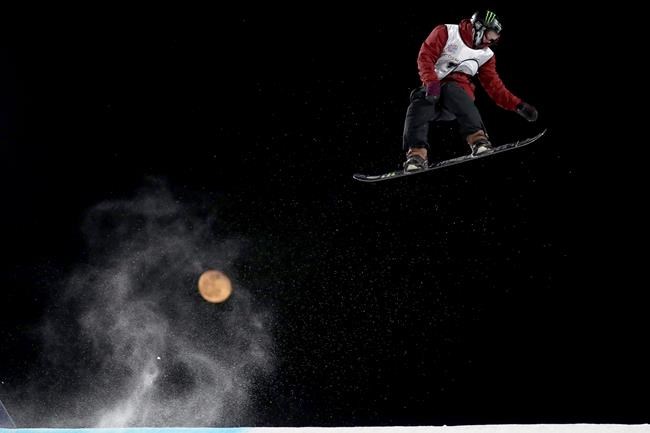Canada's Darcy Sharpe jumps, backdropped by the moon, in the Men's Snowboard Big Air for the 2019 FIS Big Air World Cup held at the Big Air Shougang in Beijing on Saturday, Dec. 14, 2019. Darcy Sharpe says he goes to sleep feeling happy these days.The snowboarder from Comox, B.C., won his first X Games gold medal last month in Aspen, Colo., and the 24-year-old is among 52 Canadian snowboarders and freestyle skiers competing against the world's best Friday to Sunday at a World Cup in Calgary. THE CANADIAN PRESS/AP, Ng Han Guan